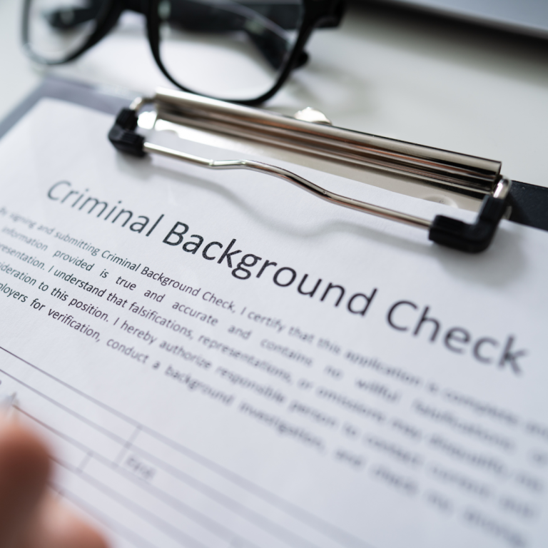 Criminal background check form on clipboard.