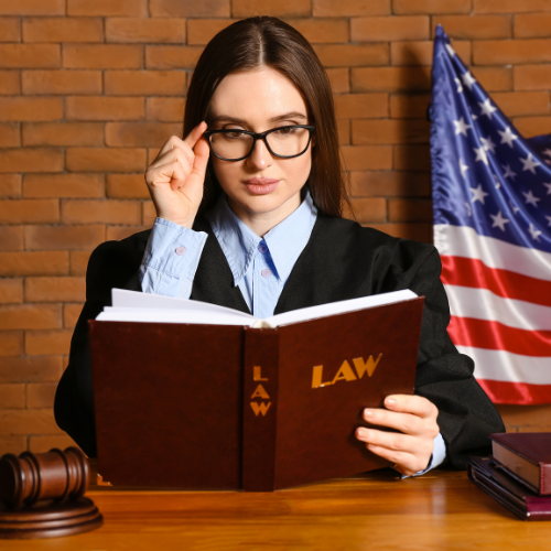 Woman reading law book explaining the burden of proof for Massachusetts Restraining Orders.